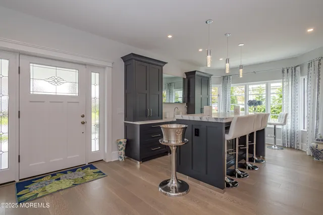 a view of a room with wooden floor and windows