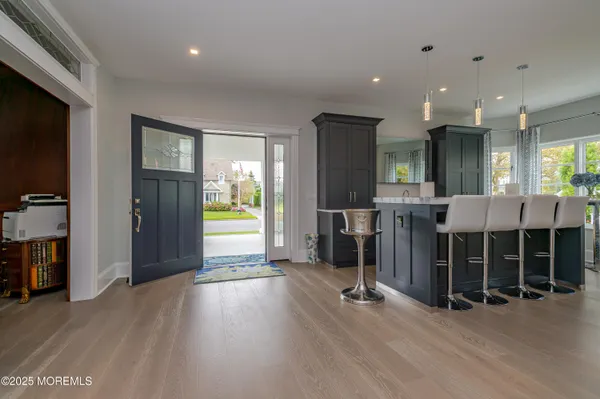 a living room with furniture and a gym machine with wooden floor