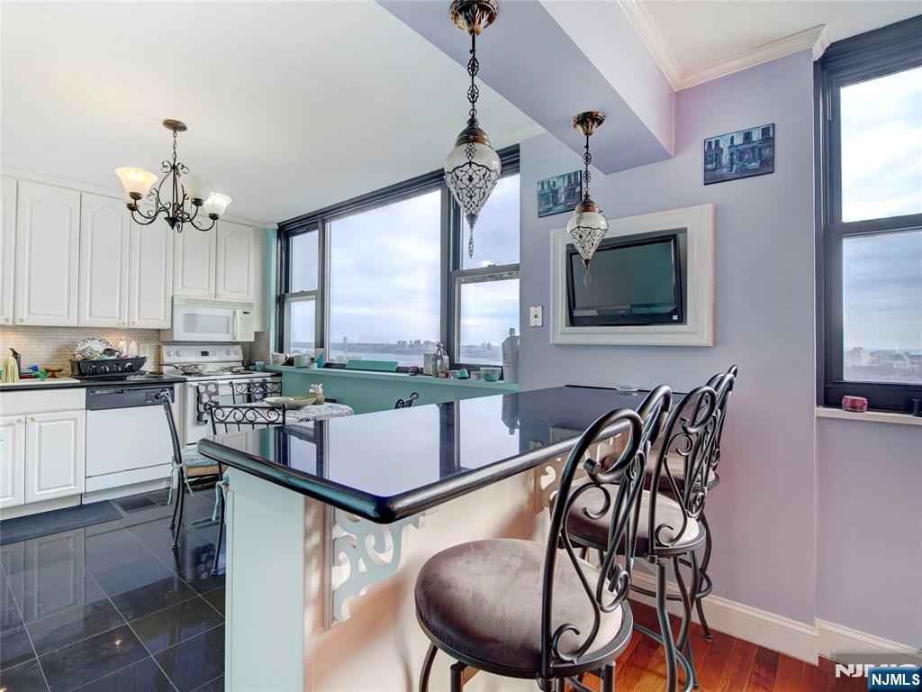250 Gorge Road, Unit 28A Cliffside Park, NJ 07010 - Photo 12 of 37 a dining room with furniture a flat screen tv and a large window