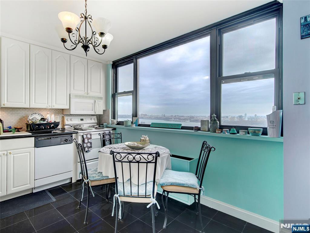 250 Gorge Road, Unit 28A Cliffside Park, NJ 07010 - Photo 13 of 37 a dining room with furniture a chandelier and window