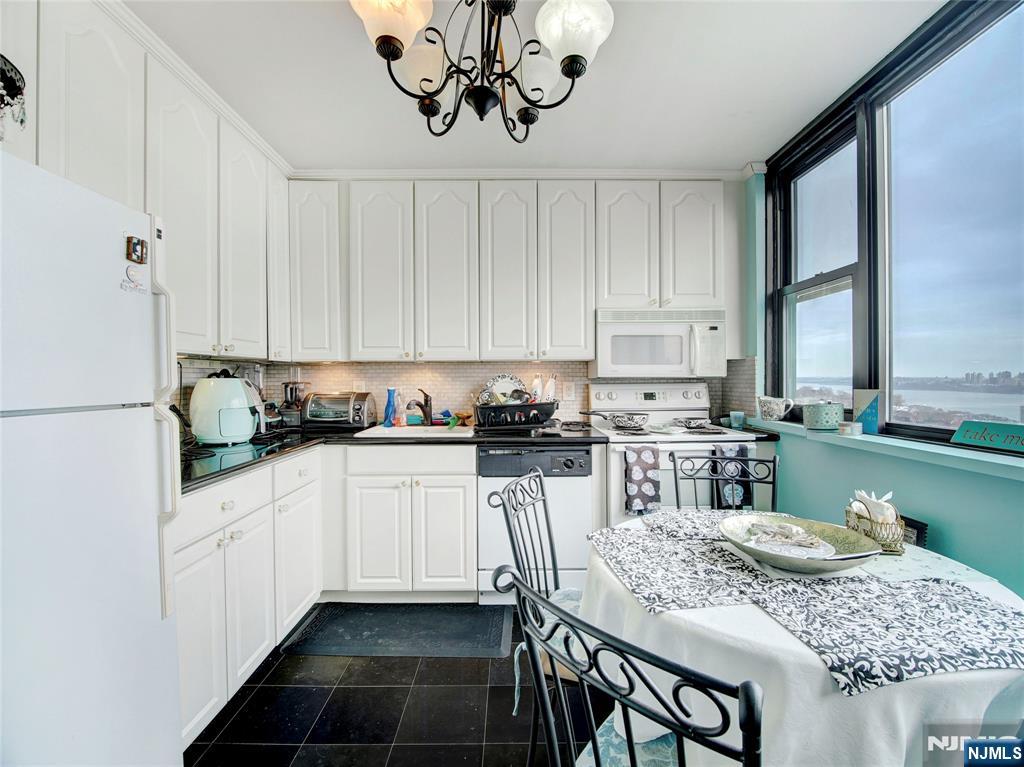 250 Gorge Road, Unit 28A Cliffside Park, NJ 07010 - Photo 14 of 37 a kitchen with stainless steel appliances granite countertop a sink stove and refrigerator