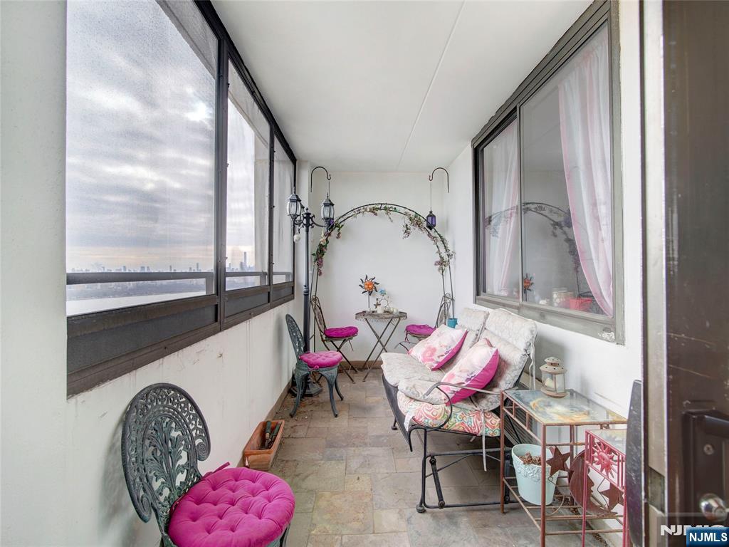 250 Gorge Road, Unit 28A Cliffside Park, NJ 07010 - Photo 18 of 37 a living room with furniture and a floor to ceiling window