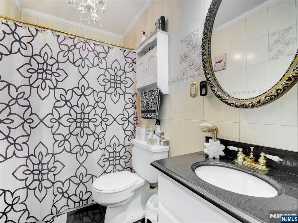 250 Gorge Road, Unit 28A Cliffside Park, NJ 07010 - Photo 6 of 37 a bathroom with a granite countertop sink mirror and toilet