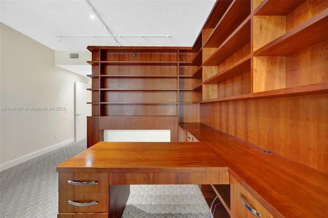 a view of an empty room with glass door