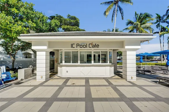 a view of a swimming pool with chairs in patio