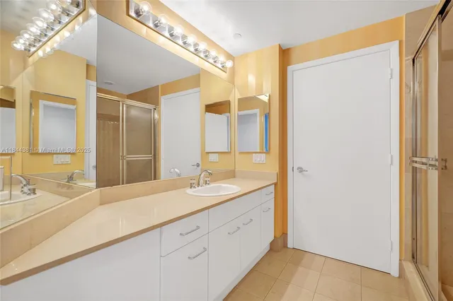 a view of a yard with plants and palm trees