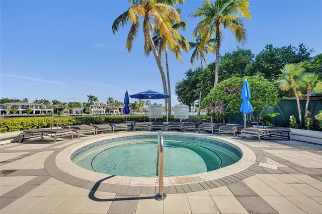 a swimming pool with outdoor seating and yard