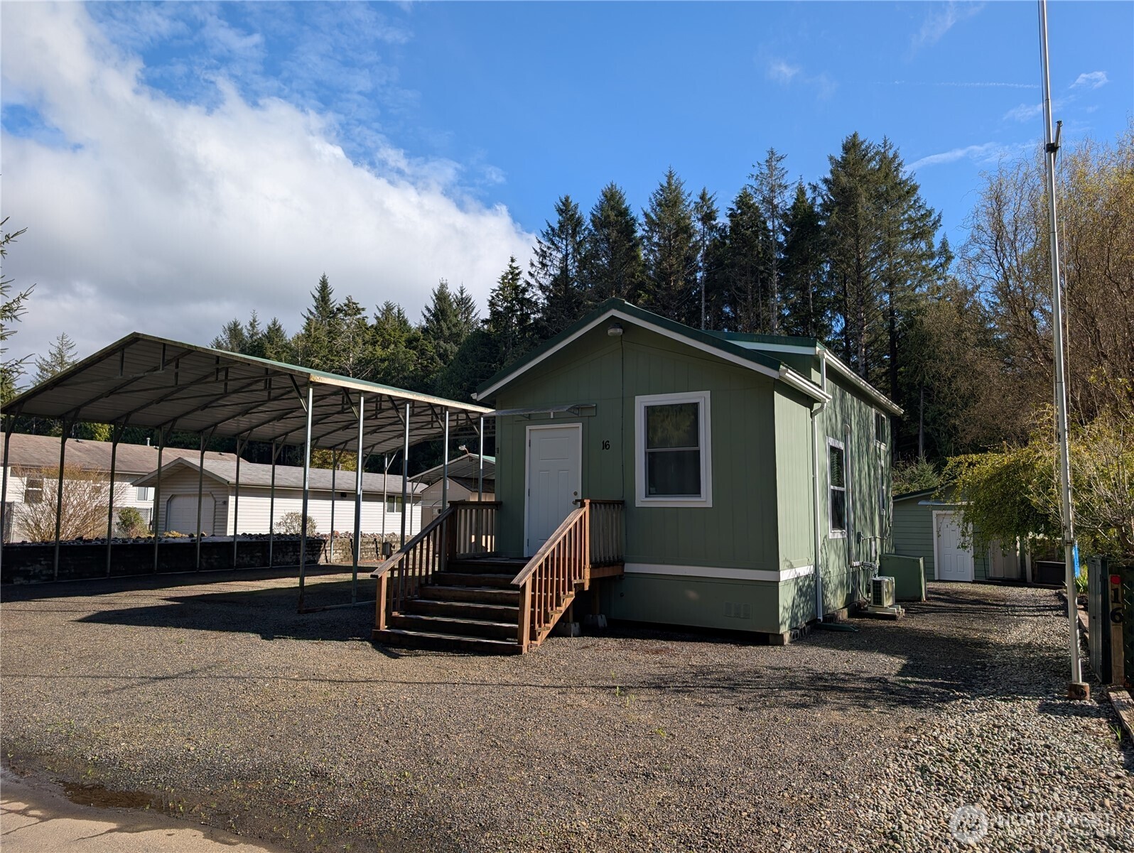 a view of house with backyard and trees