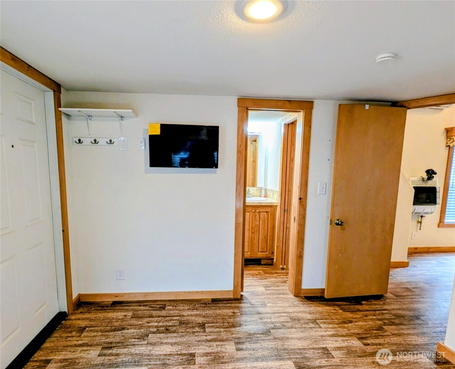 16 Copalis Rv Lane Copalis Beach, WA 98535 - Photo 11 of 39 a view of a livingroom with wooden floor and a flat screen tv