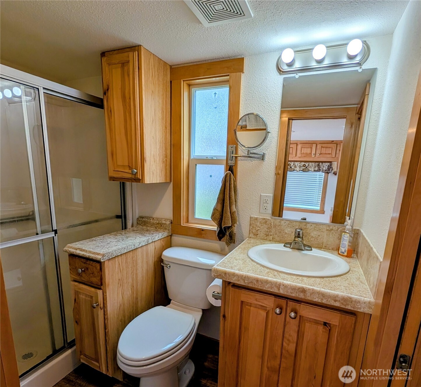 16 Copalis Rv Lane Copalis Beach, WA 98535 - Photo 12 of 39 a bathroom with a granite countertop toilet sink and mirror