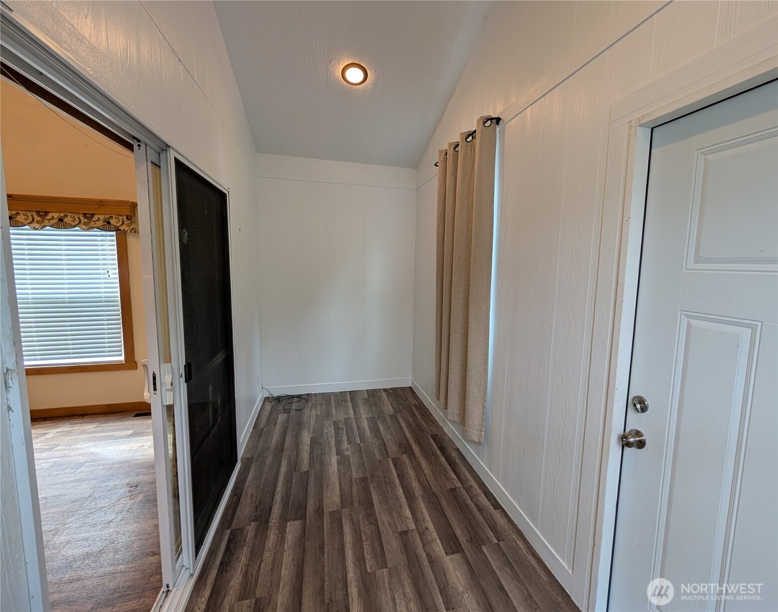 16 Copalis Rv Lane Copalis Beach, WA 98535 - Photo 4 of 39 a view of a hallway with wooden floor and a livingroom