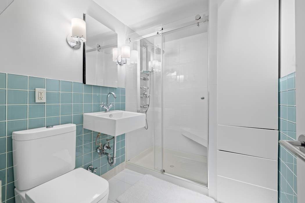 32 West 40th Street, Unit 11B Manhattan, NY 10018 - Photo 4 of 9 a bathroom with a toilet a sink and shower