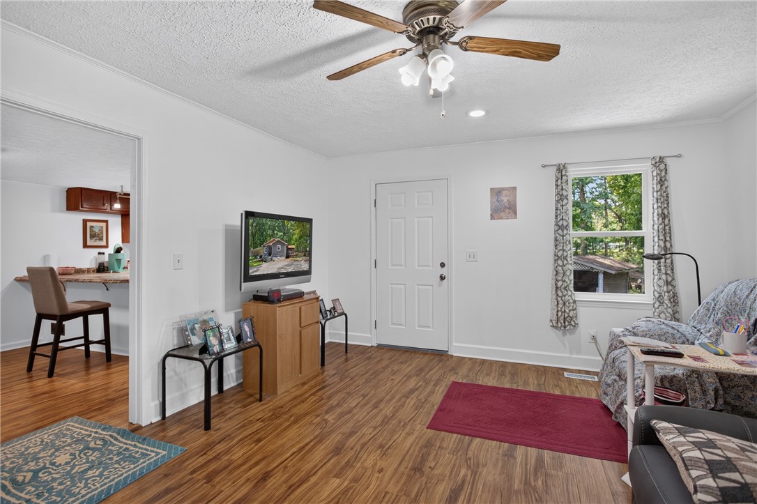 230 Dickard Road Seneca, SC 29672 - Photo 9 of 25 A welcoming interior offers durable wood flooring and ample natural light from an outdoor view.