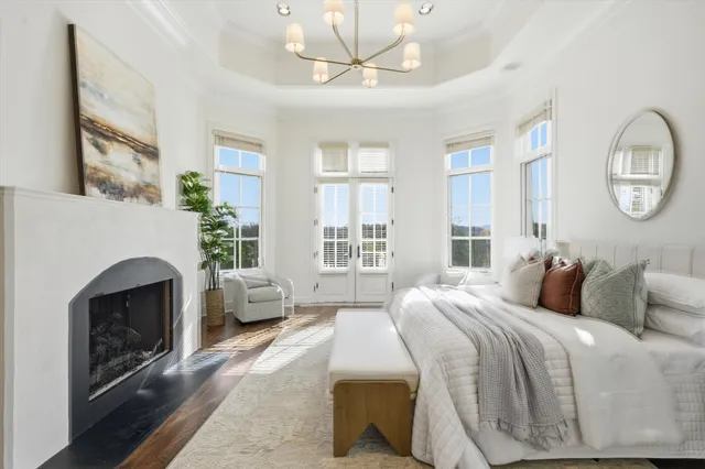 a living room with furniture a fireplace and windows