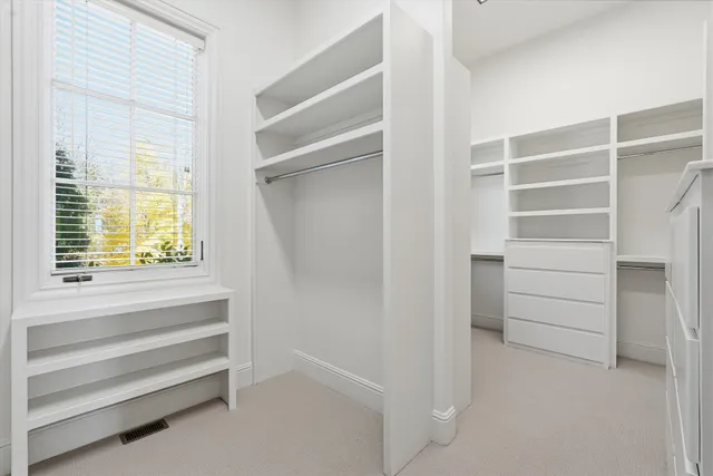 a living room with furniture a potted plant and a large window