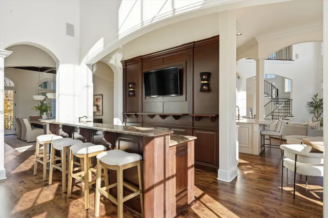a view of a hallway with wooden floor and entryway