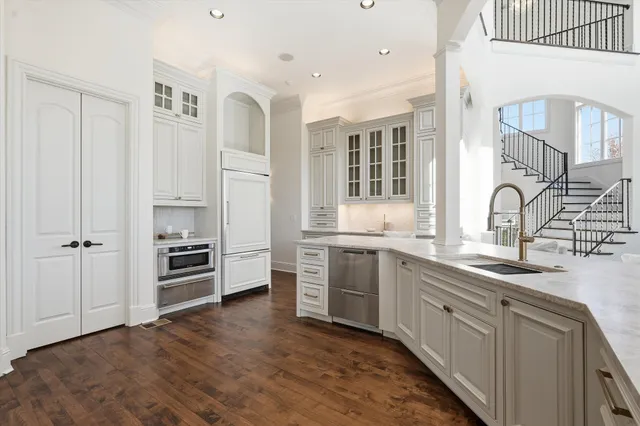 a kitchen with stainless steel appliances granite countertop a sink and dishwasher with wooden floor