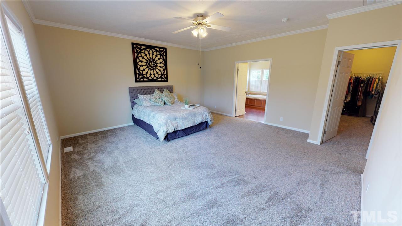 1920 Sanders Road Willow Spring, NC 27592 - Photo 13 of 29 a living room with furniture and a ceiling fan