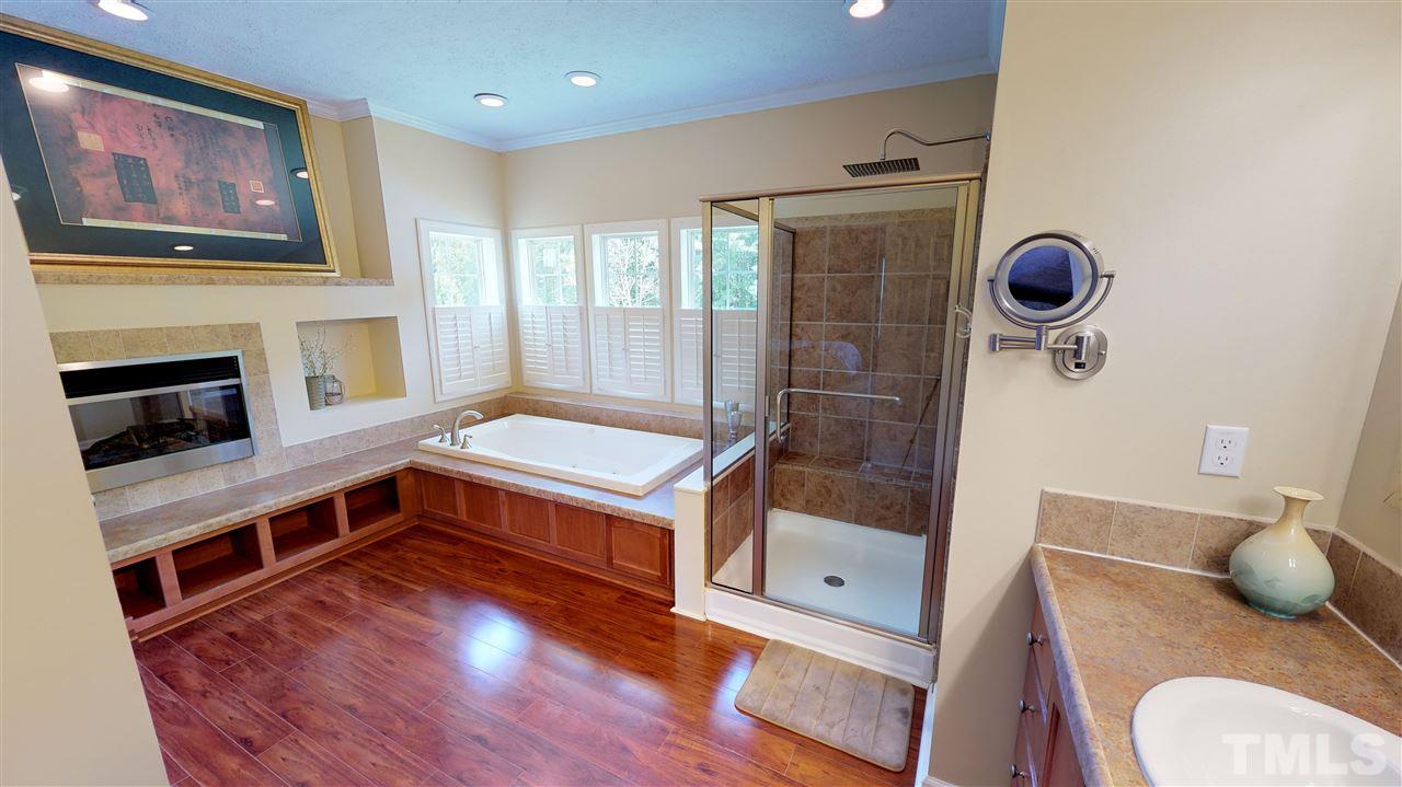 1920 Sanders Road Willow Spring, NC 27592 - Photo 15 of 29 a kitchen with stainless steel appliances granite countertop a stove a sink a refrigerator and wooden floor