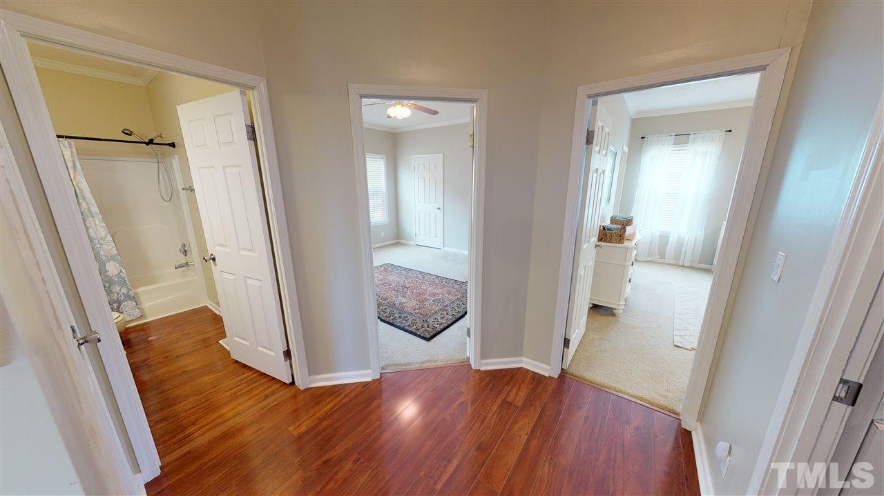 1920 Sanders Road Willow Spring, NC 27592 - Photo 17 of 29 wooden floor with a table and a mirror