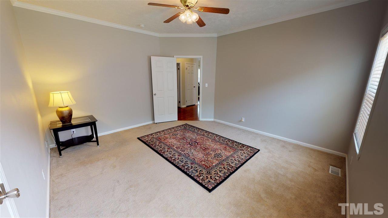 1920 Sanders Road Willow Spring, NC 27592 - Photo 19 of 29 a living room with furniture rug and window