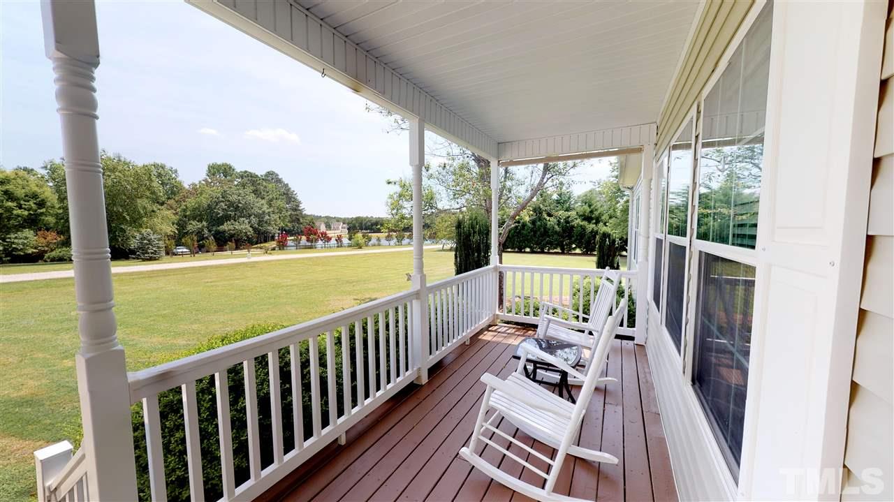 1920 Sanders Road Willow Spring, NC 27592 - Photo 3 of 29 a view of balcony with wooden floor and outdoor seating