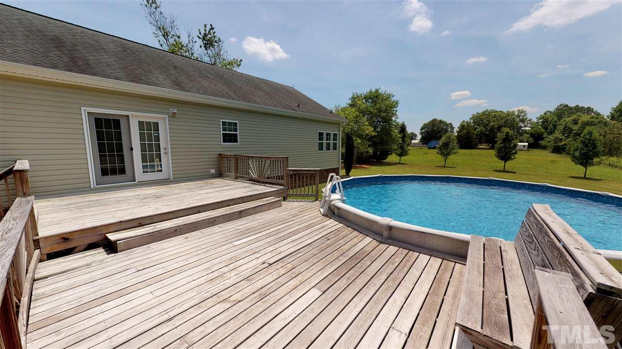 1920 Sanders Road Willow Spring, NC 27592 - Photo 25 of 29 a swimming pool with barbeque oven and outdoor seating