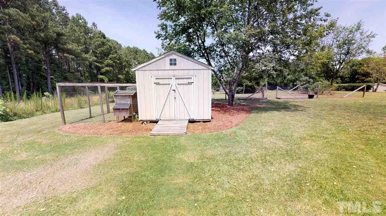 1920 Sanders Road Willow Spring, NC 27592 - Photo 28 of 29 a white house that has a tree in front of it