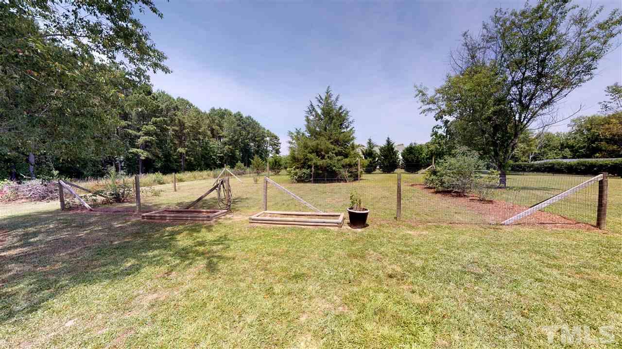 1920 Sanders Road Willow Spring, NC 27592 - Photo 29 of 29 a view of white house with a yard