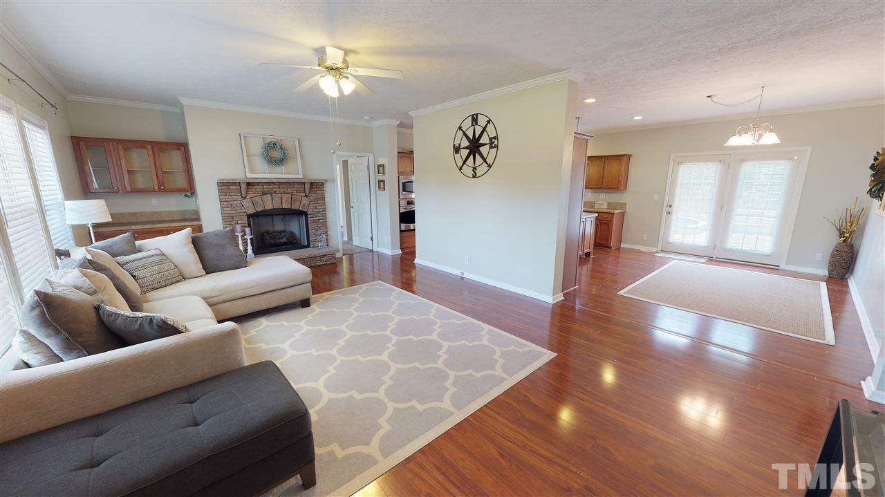 1920 Sanders Road Willow Spring, NC 27592 - Photo 4 of 29 a living room with furniture and a fireplace