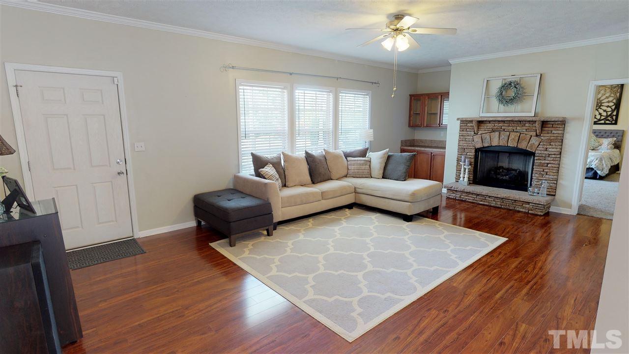 1920 Sanders Road Willow Spring, NC 27592 - Photo 5 of 29 a living room with furniture and a fireplace