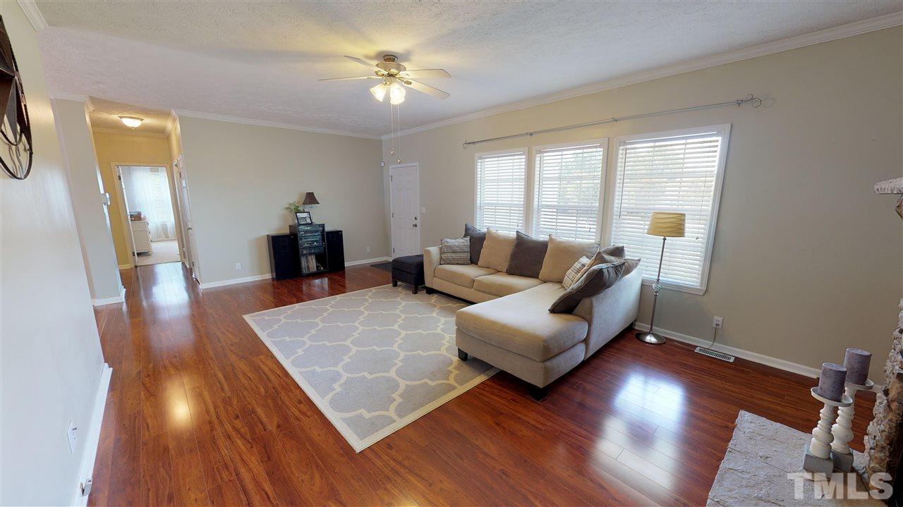 1920 Sanders Road Willow Spring, NC 27592 - Photo 6 of 29 a living room with furniture and a large window