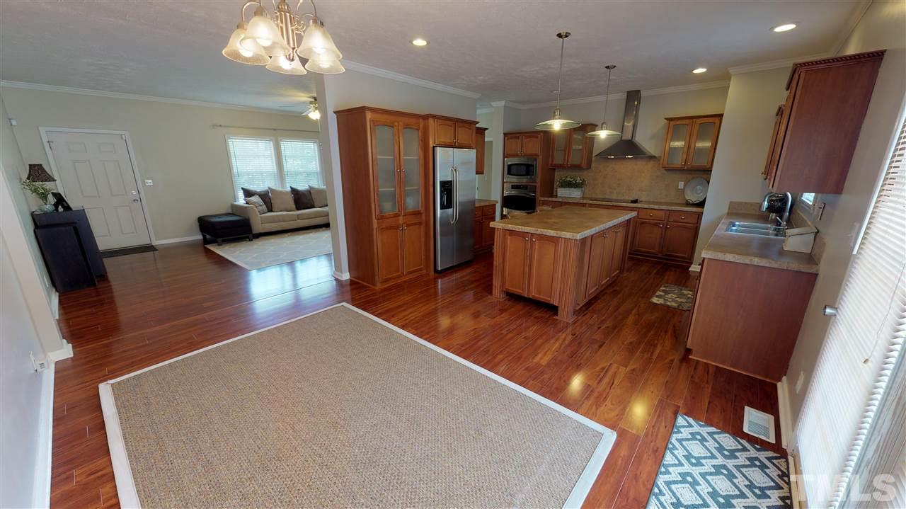 1920 Sanders Road Willow Spring, NC 27592 - Photo 9 of 29 a living room with furniture and a flat screen tv