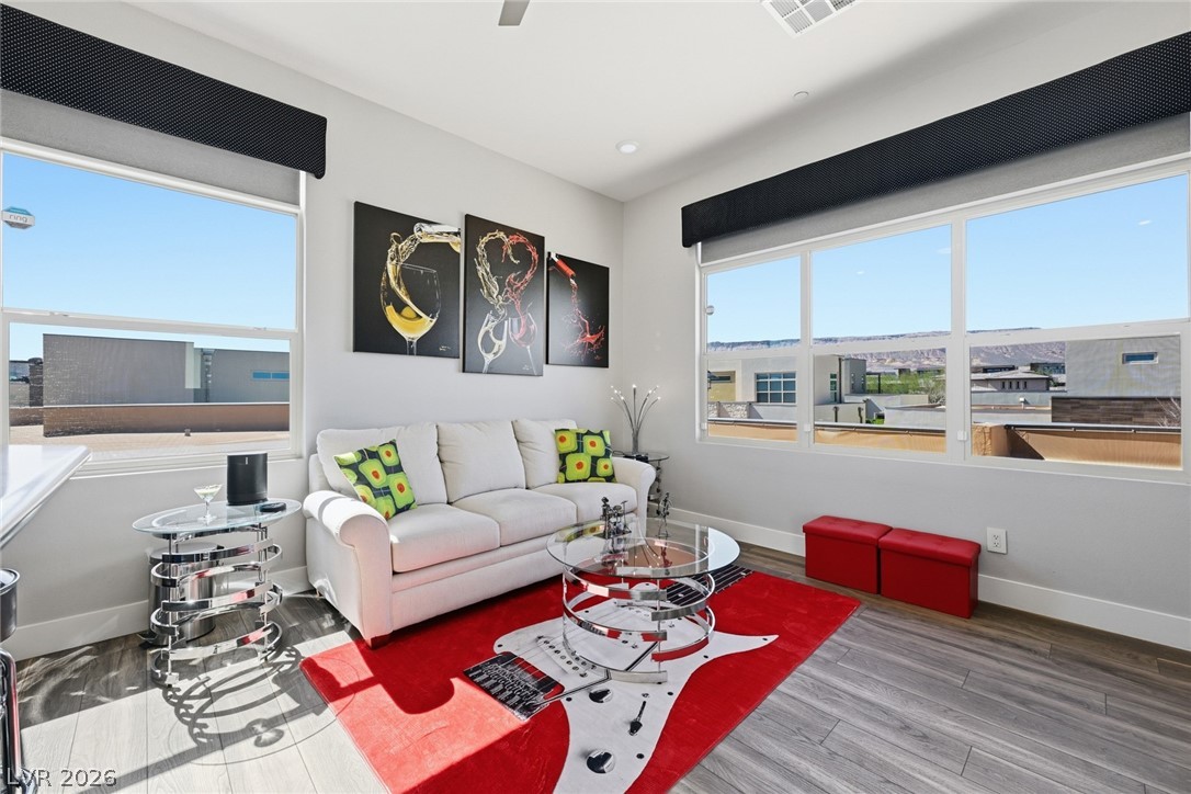 4246 Swift Street Las Vegas, NV 89135 - Photo 30 of 71 Living room featuring healthy amount of natural light, light wood-style floors, and ceiling fan