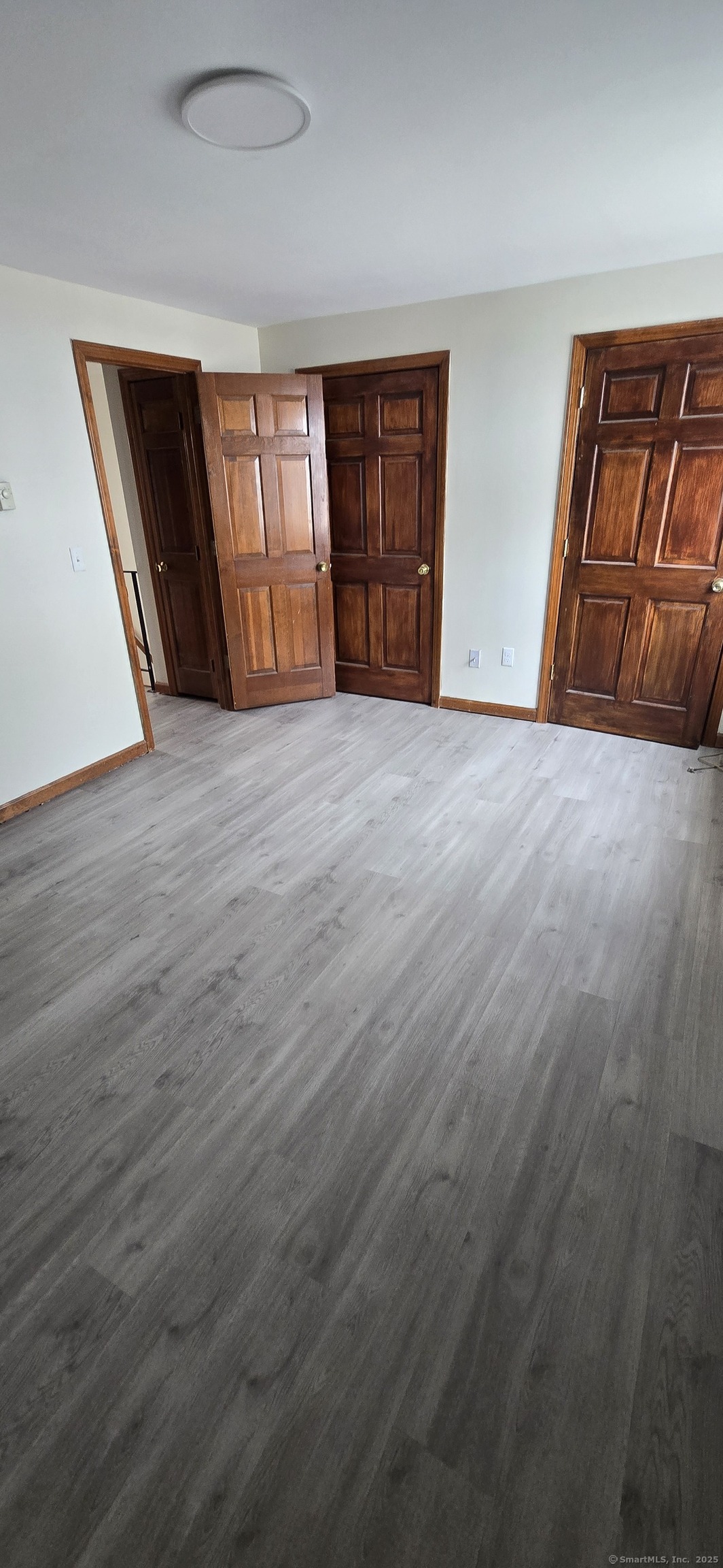 106 Wakelee Road, Unit 1 Waterbury, CT 06705 - Photo 13 of 19 an empty room with a fireplace and wooden floor