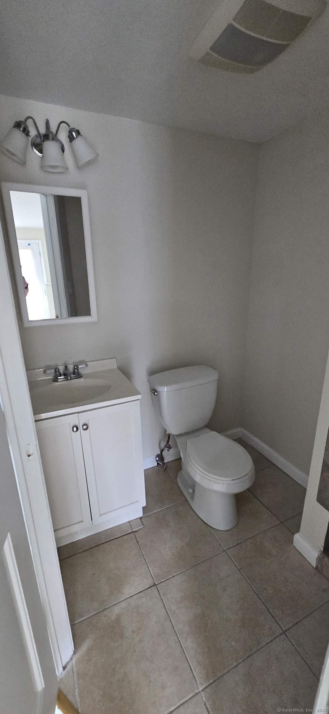 106 Wakelee Road, Unit 1 Waterbury, CT 06705 - Photo 16 of 19 a bathroom with a toilet sink and mirror