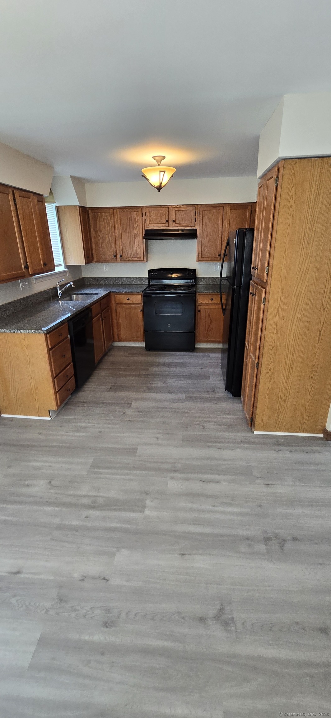 106 Wakelee Road, Unit 1 Waterbury, CT 06705 - Photo 5 of 19 a view of kitchen with wooden floor