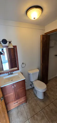 a bathroom with a toilet and a mirror