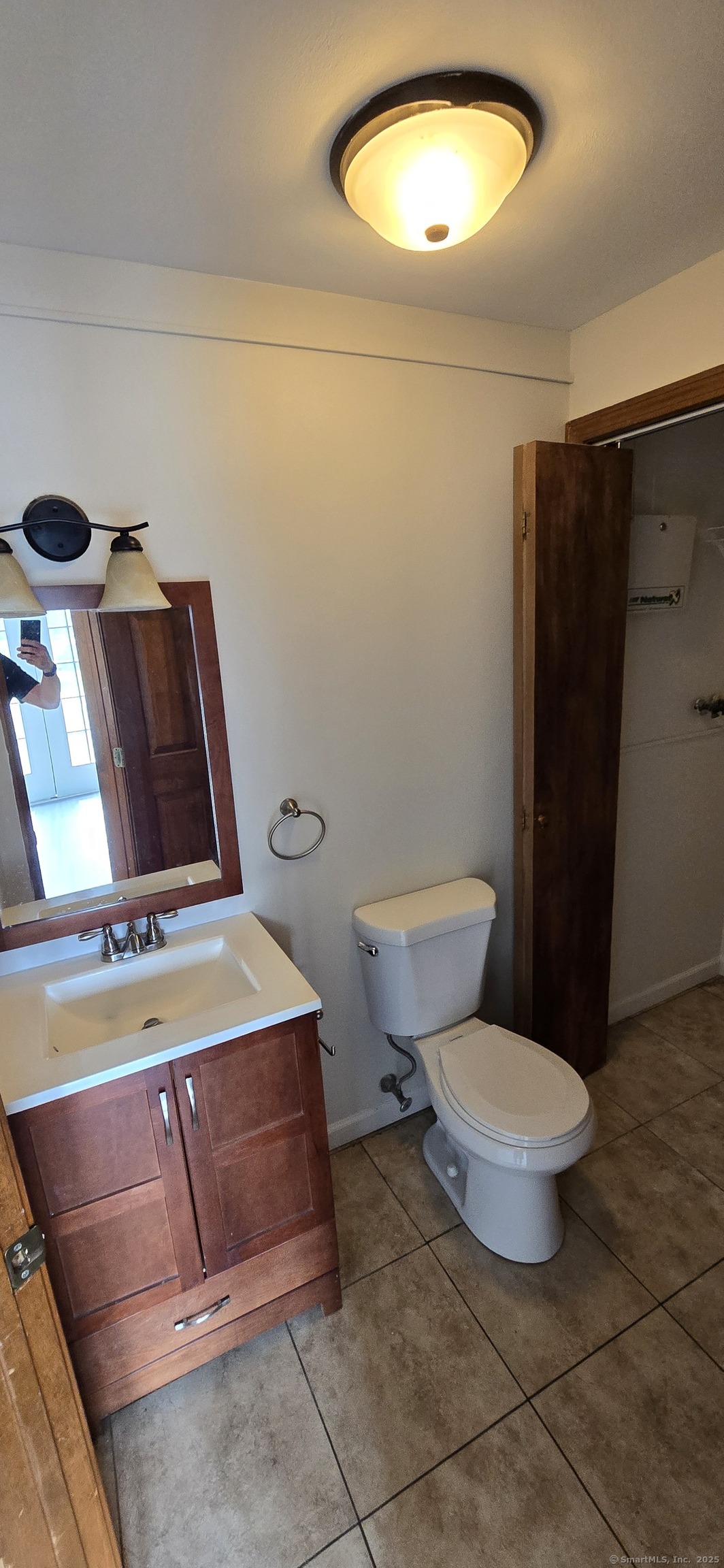 106 Wakelee Road, Unit 1 Waterbury, CT 06705 - Photo 7 of 19 a bathroom with a toilet and a mirror