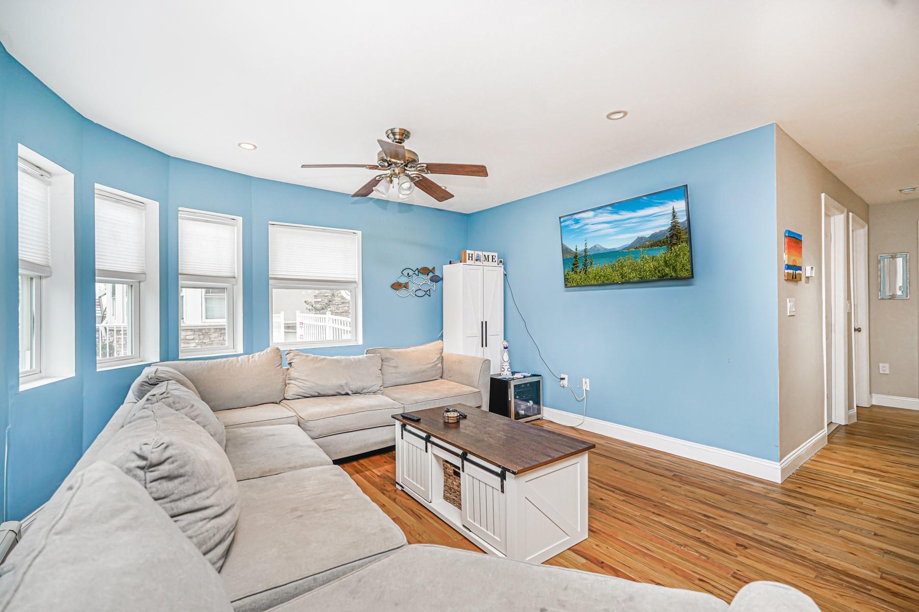 175 Beach 100th Street, Unit 8A Queens, NY 11694 - Photo 11 of 24 a living room with furniture and a flat screen tv