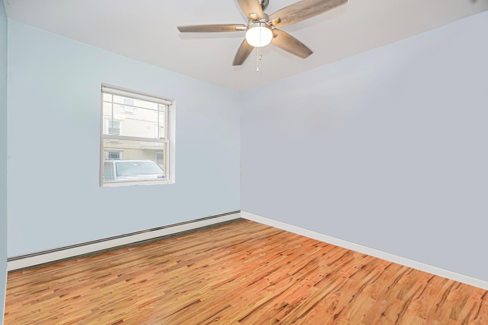 175 Beach 100th Street, Unit 8A Queens, NY 11694 - Photo 20 of 24 a view of empty room with wooden floor