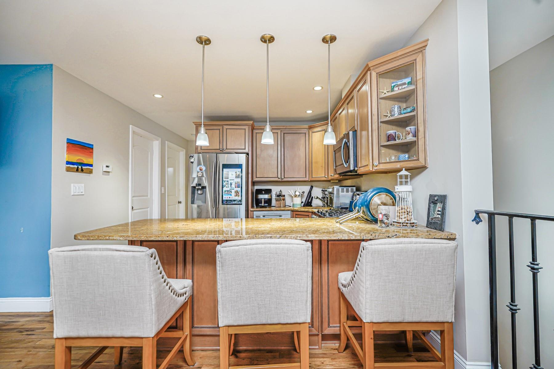 175 Beach 100th Street, Unit 8A Queens, NY 11694 - Photo 6 of 24 a dining room with a table chairs and refrigerator