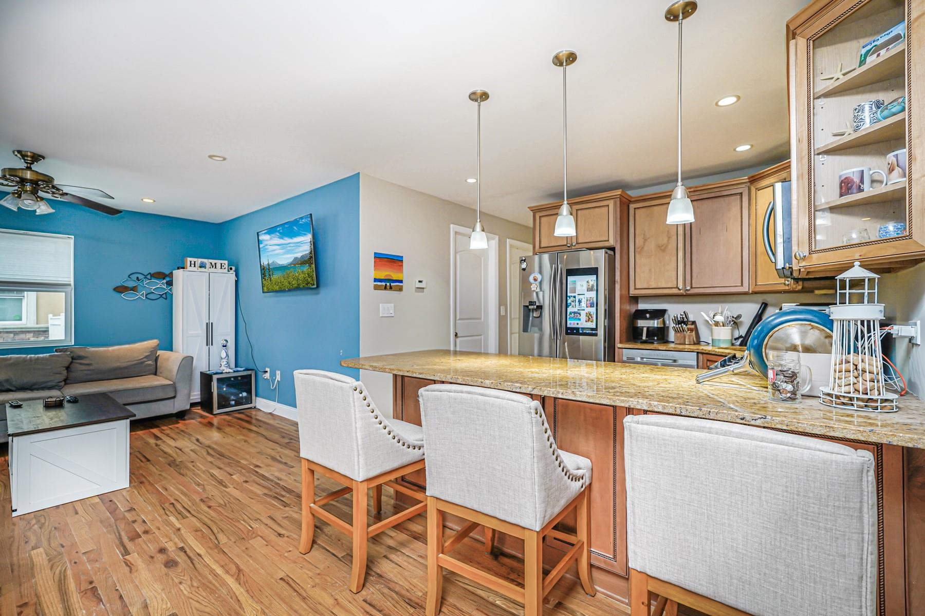175 Beach 100th Street, Unit 8A Queens, NY 11694 - Photo 8 of 24 a large kitchen with a table and chairs