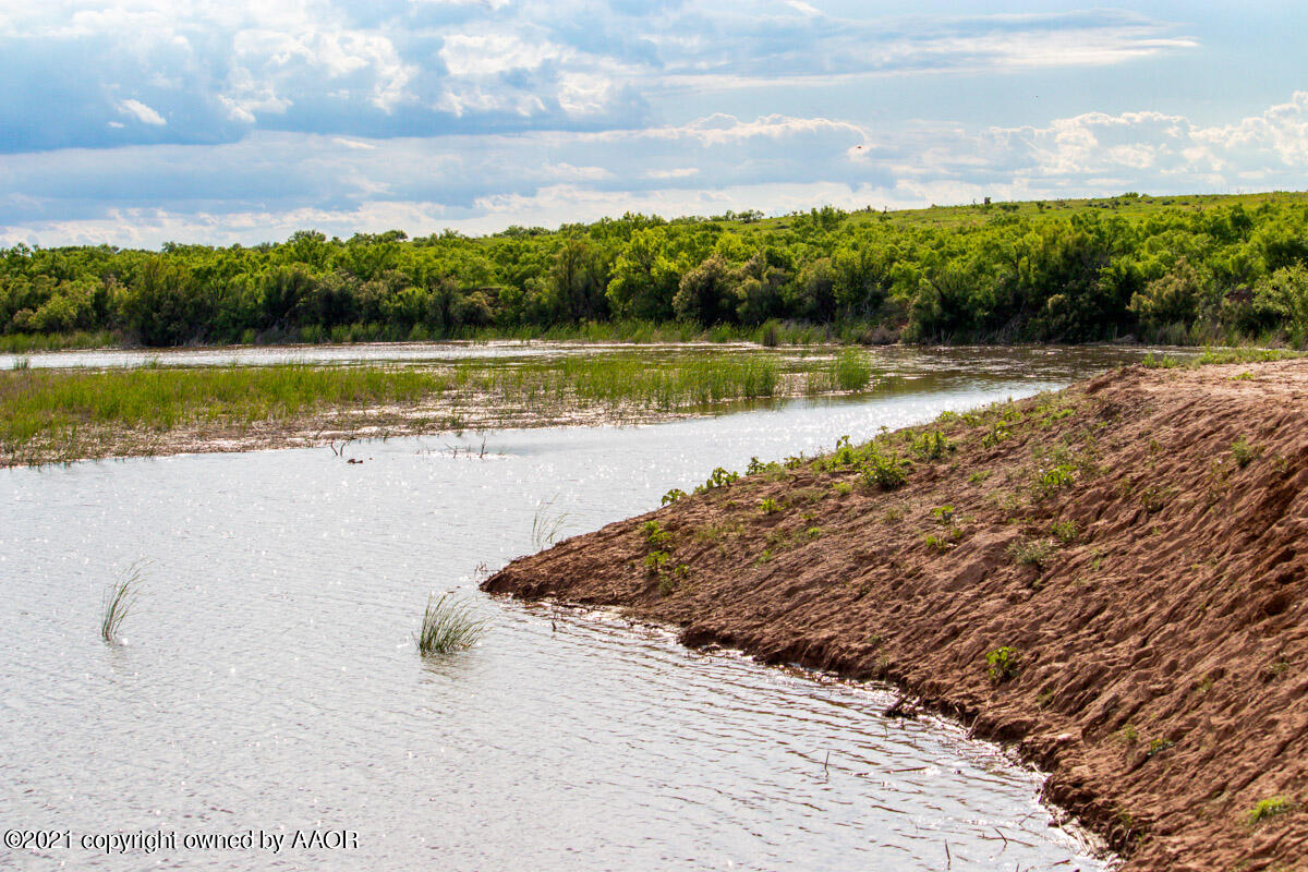 Ol' Glory Ranch Matador, TX 79244 - Photo 35 of 59 a view of a lake with houses in the back