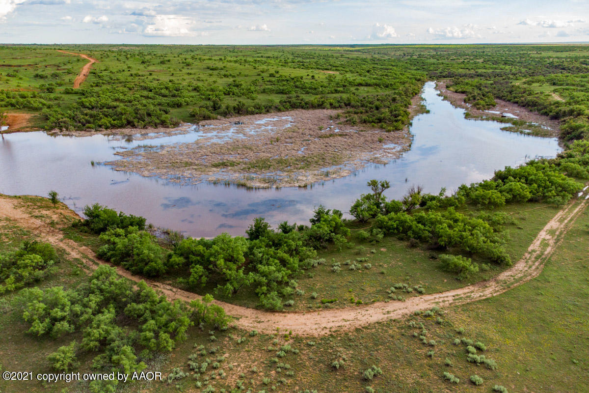 Ol' Glory Ranch Matador, TX 79244 - Photo 57 of 59 a view of a lake with beach and city view