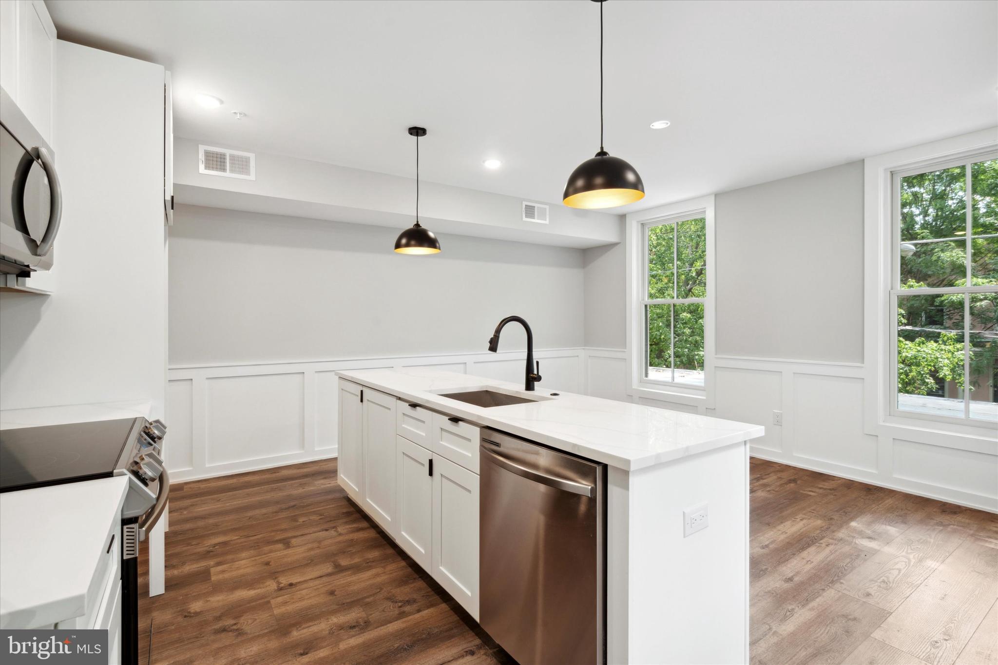 3519 Hamilton Street, Unit 3 Philadelphia, PA 19104 - Photo 7 of 16 a kitchen with sink stove and wooden floor