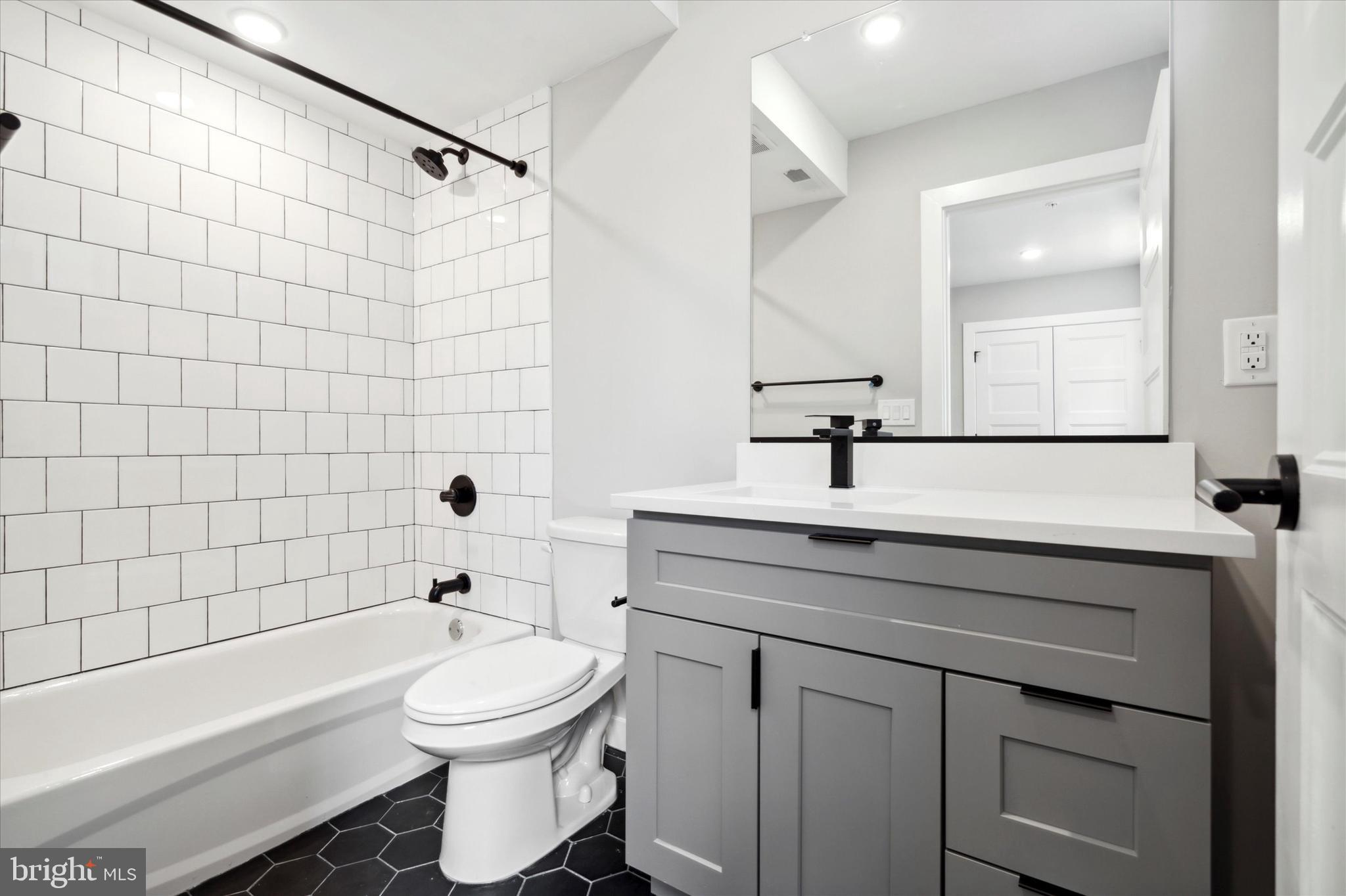 3519 Hamilton Street, Unit 3 Philadelphia, PA 19104 - Photo 10 of 16 a bathroom with a sink a toilet and shower