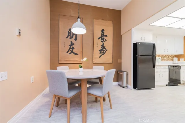 a dining room with furniture and a refrigerator