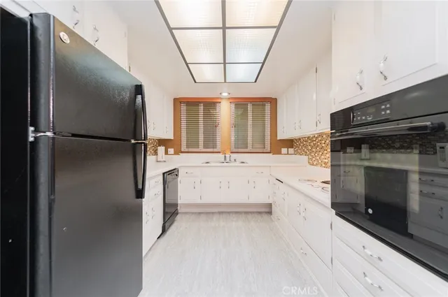a kitchen with a refrigerator and a stove