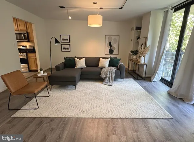 a living room with furniture and a chandelier